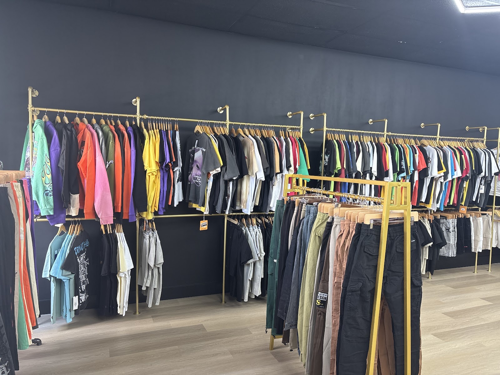 Moody boutique interior with racks of dark garments