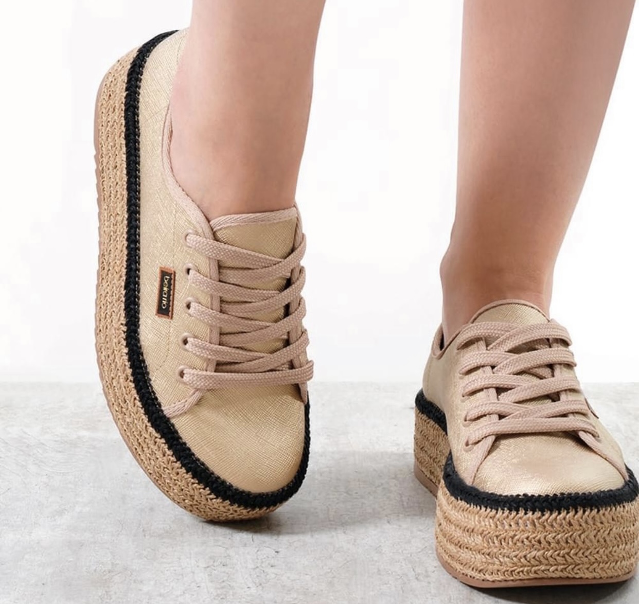 Grey knit Angy’s sneakers tossed in the air