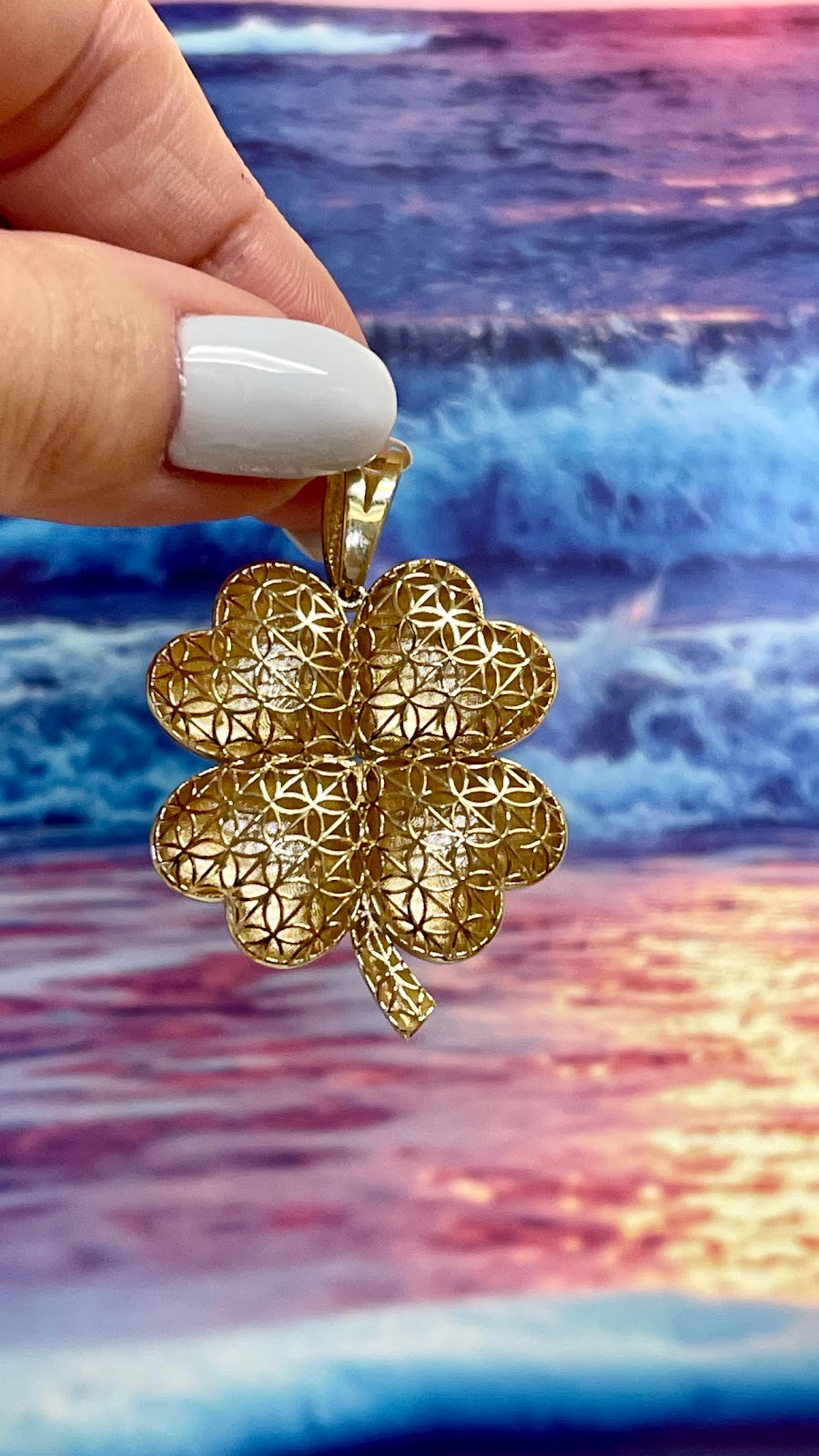 A radiant gold sunburst pendant on a fine chain
