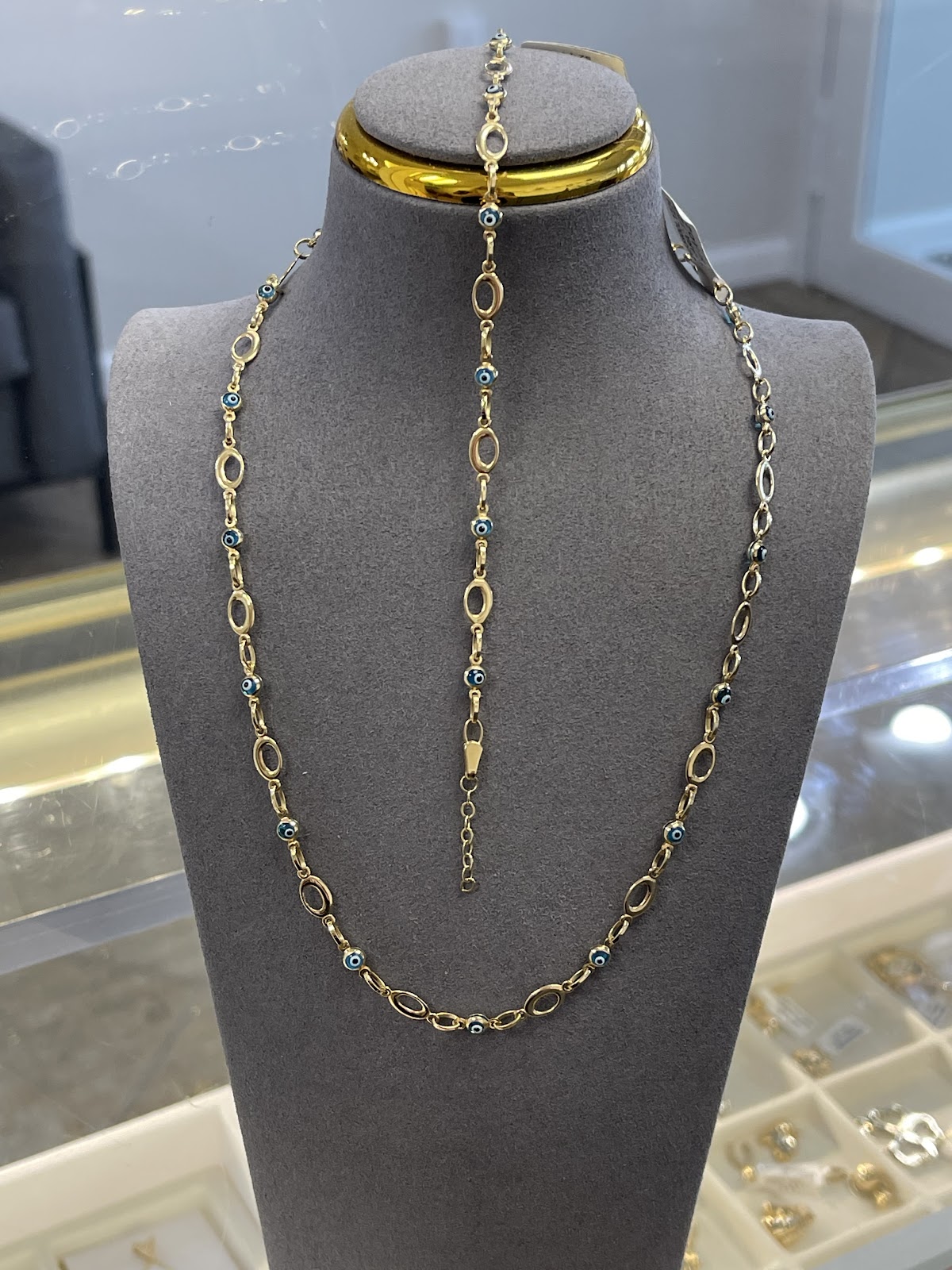 Layered fine gold necklaces at the collarbone