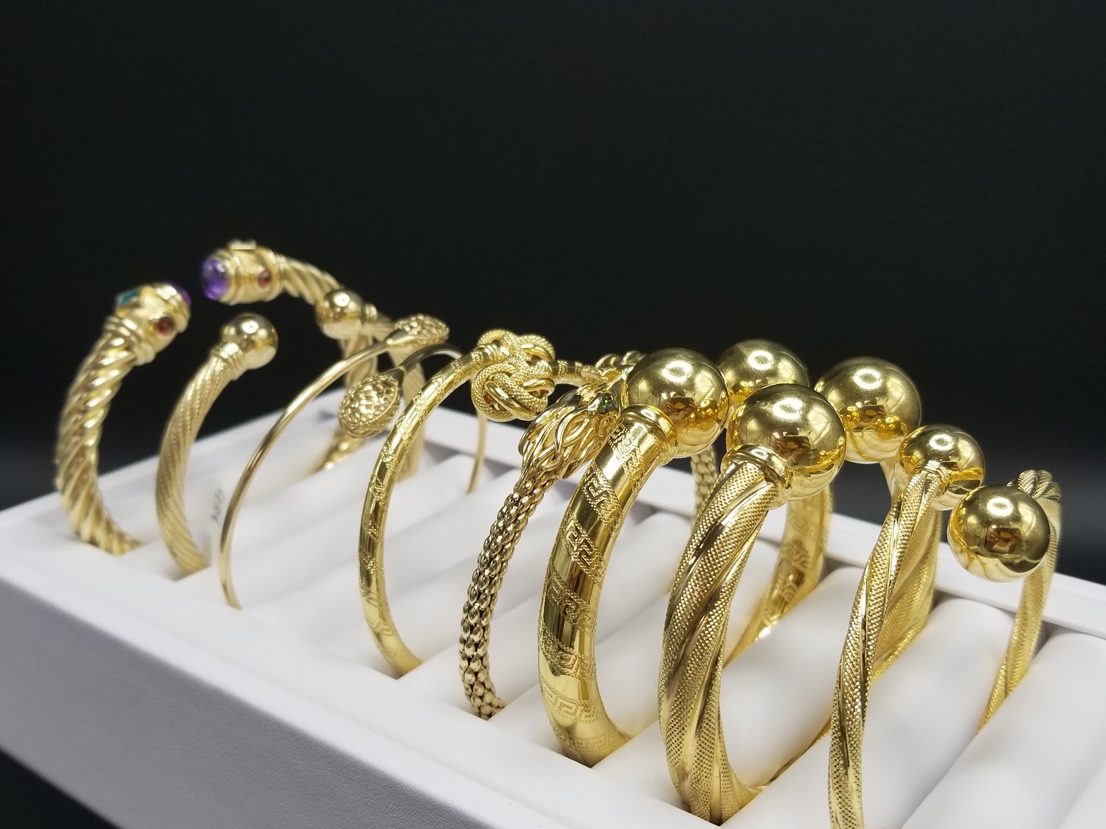 Model wearing a sculptural gold hoop earring
