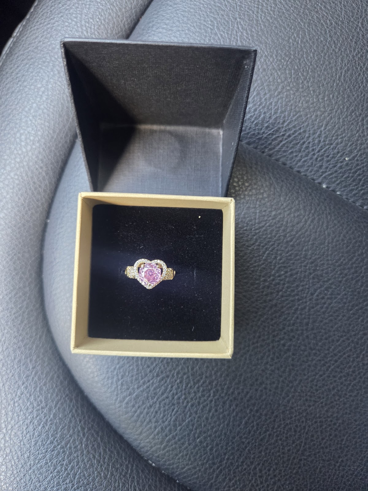 Pink sapphire ring set in rose gold with a diamond halo