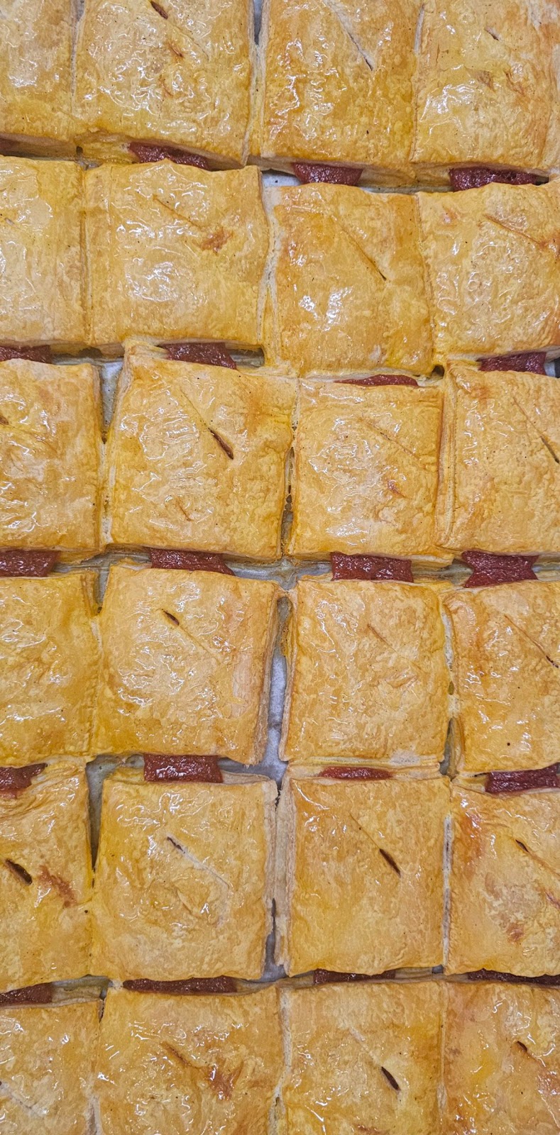 A glass display case full of fresh danishes and pastries