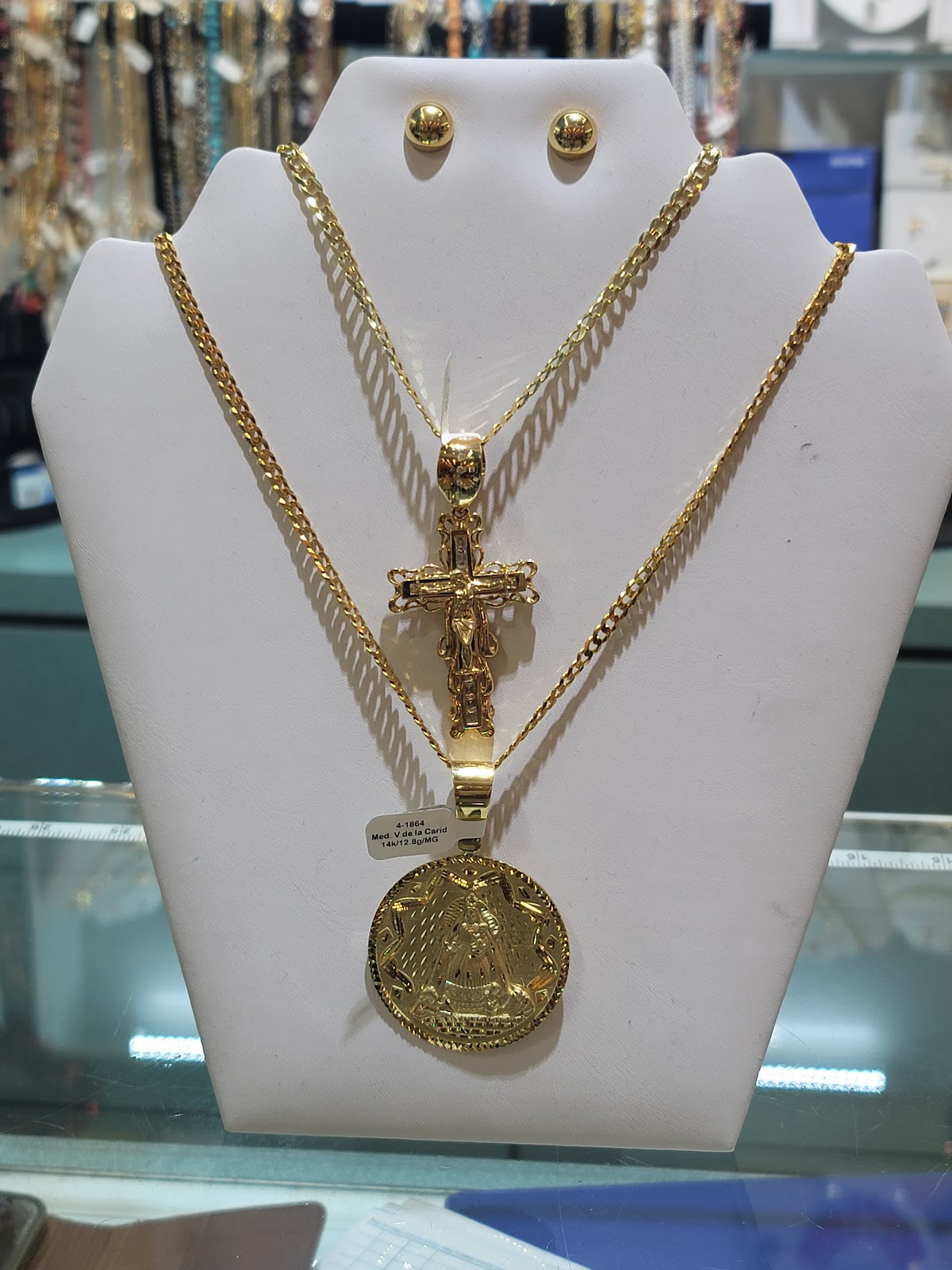 A slim gold chain against a dark tailored blazer