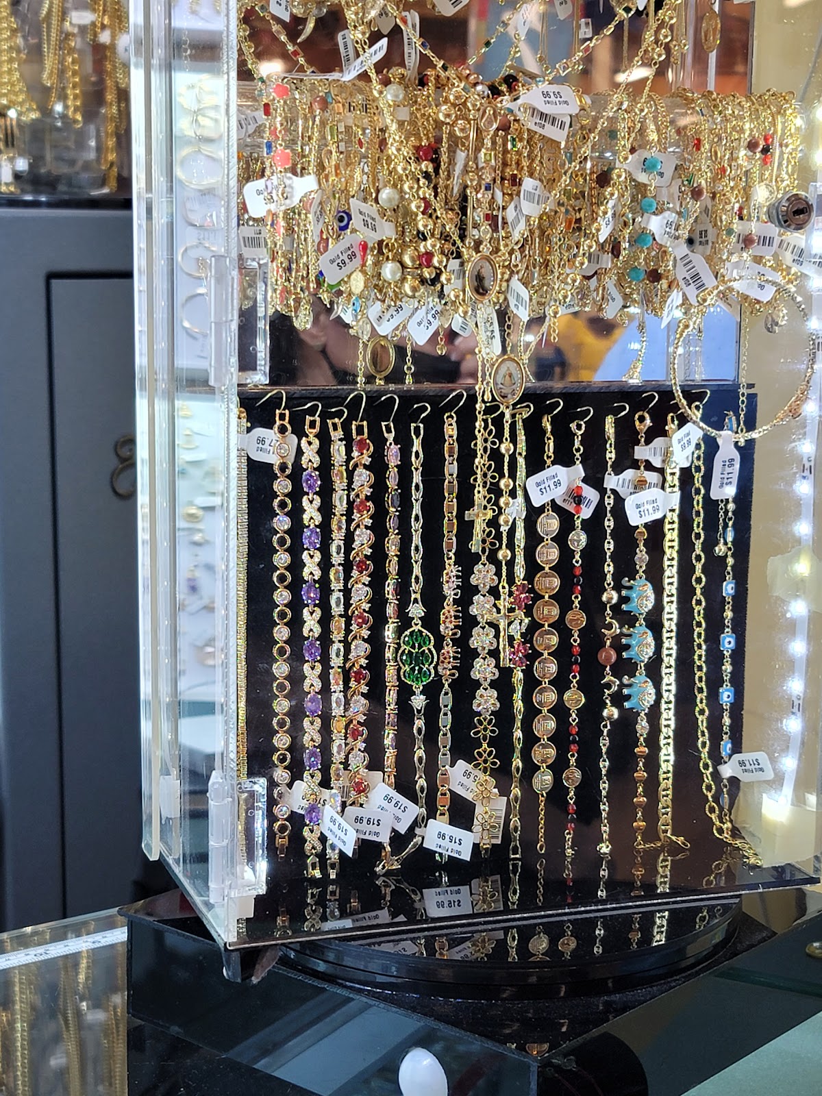 Layered fine gold necklaces at the collarbone