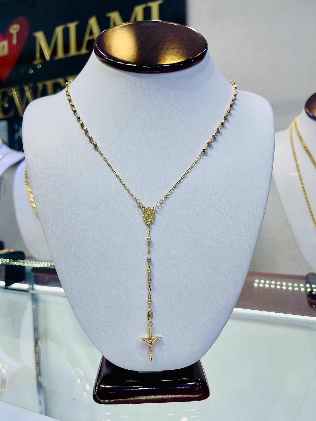A radiant gold sunburst pendant on a fine chain
