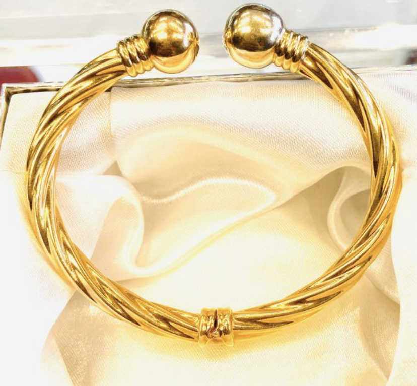 A diamond bracelet resting on black velvet, catching light
