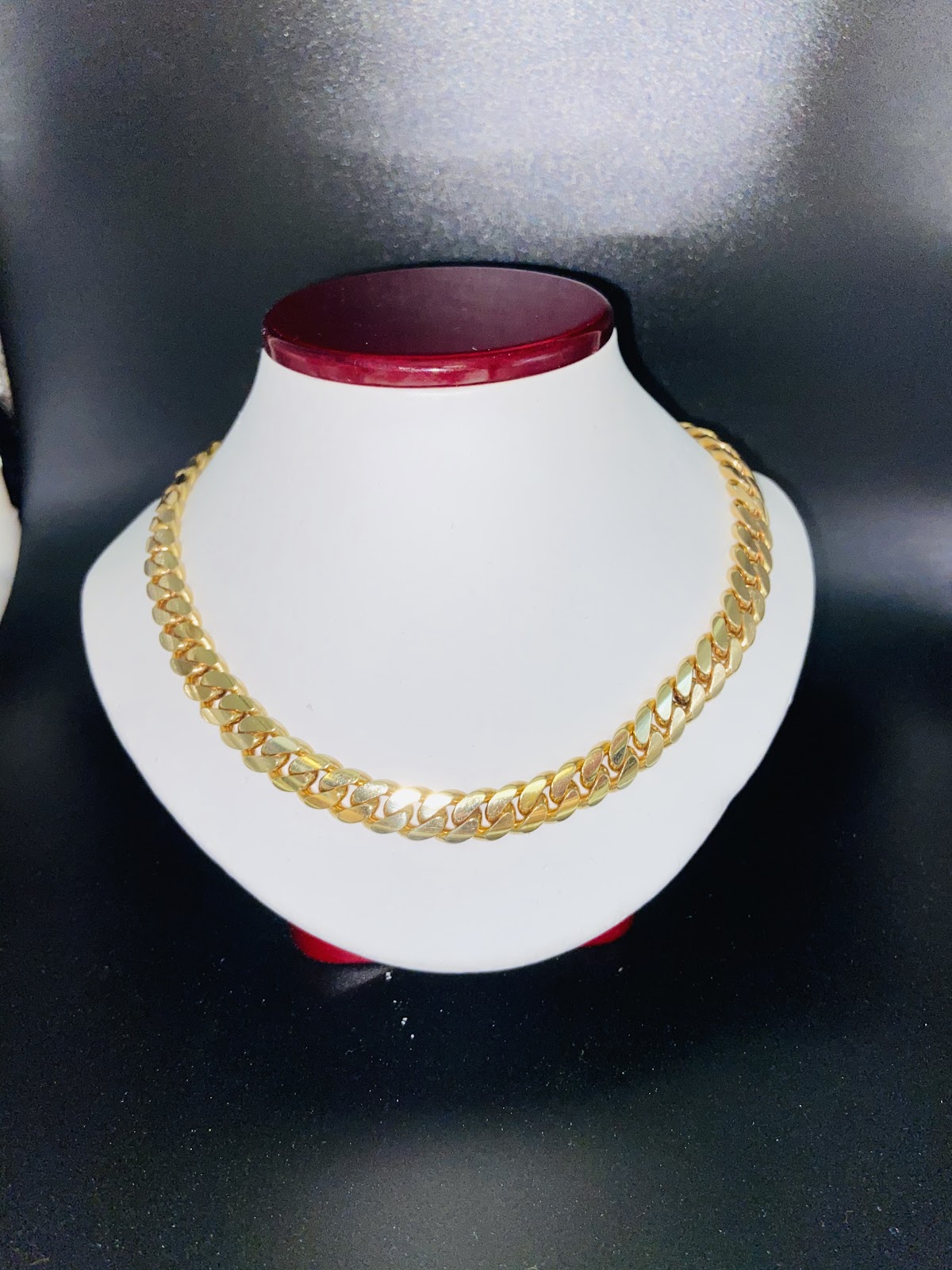 Layered fine gold necklaces at the collarbone