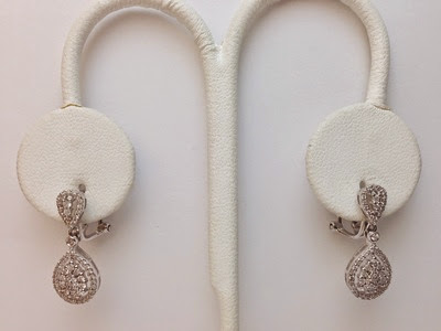 A delicate drop earring worn on the ear