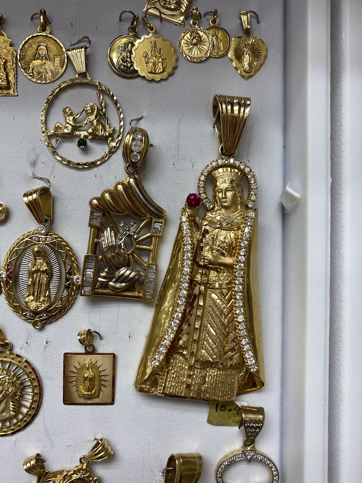 A radiant gold sunburst pendant on a fine chain