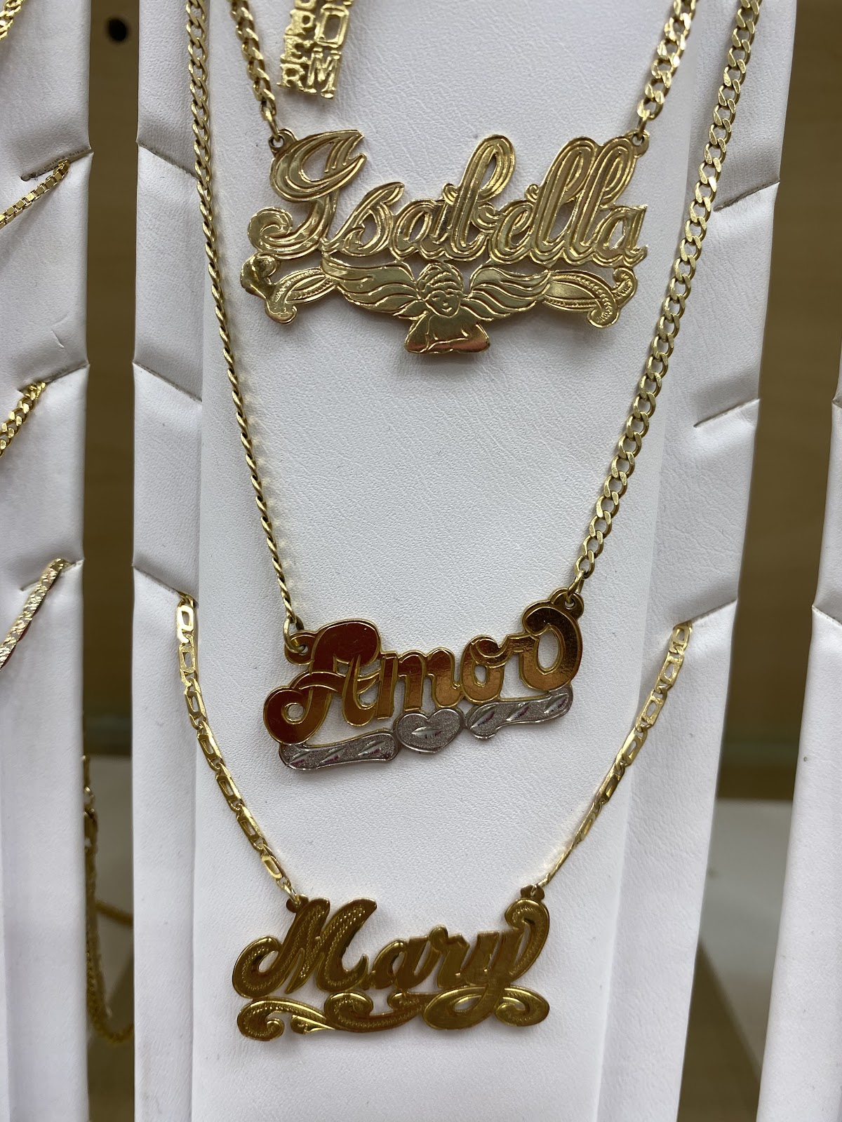 A slim gold chain against a dark tailored blazer