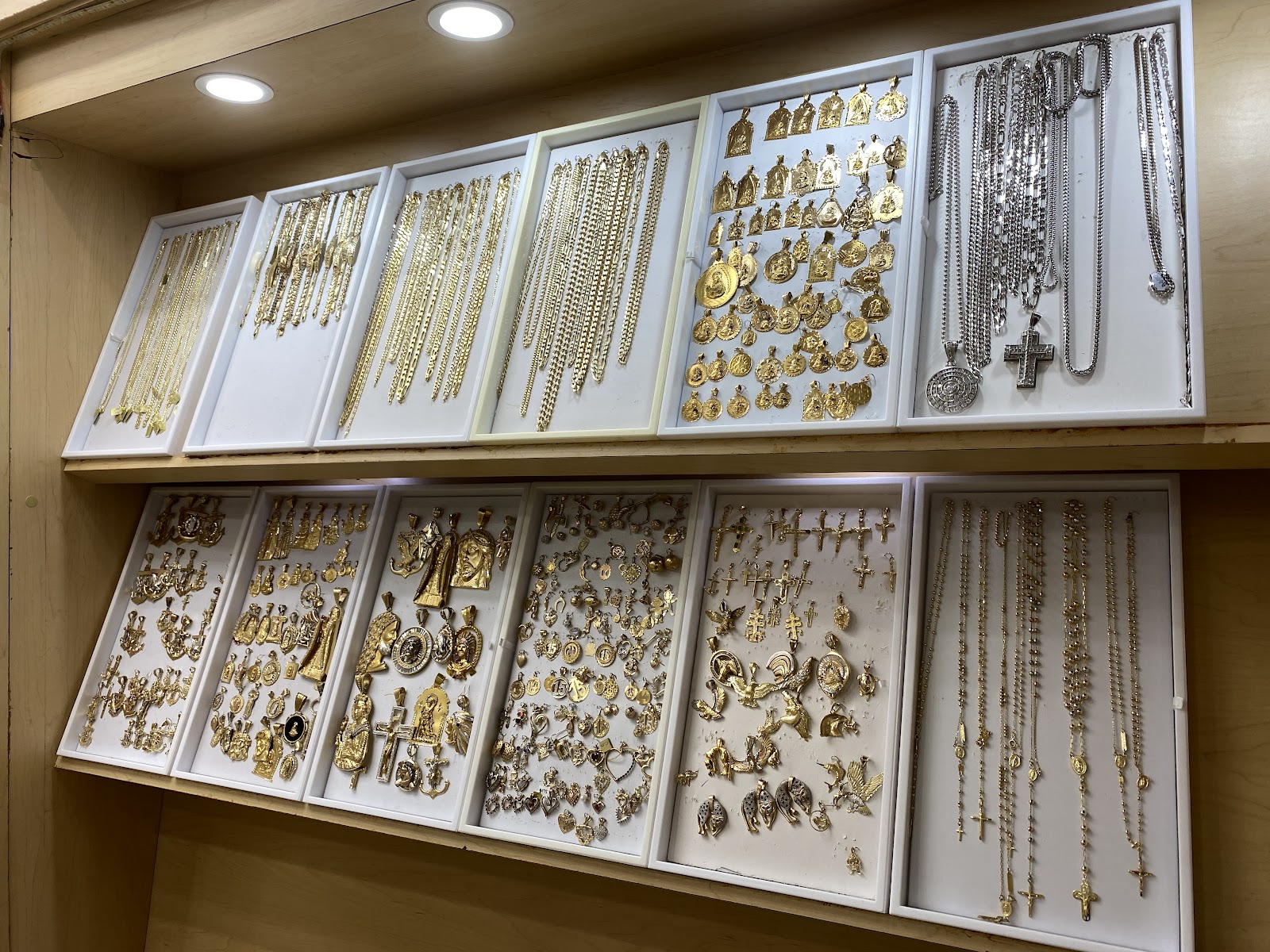 Layered fine gold necklaces at the collarbone
