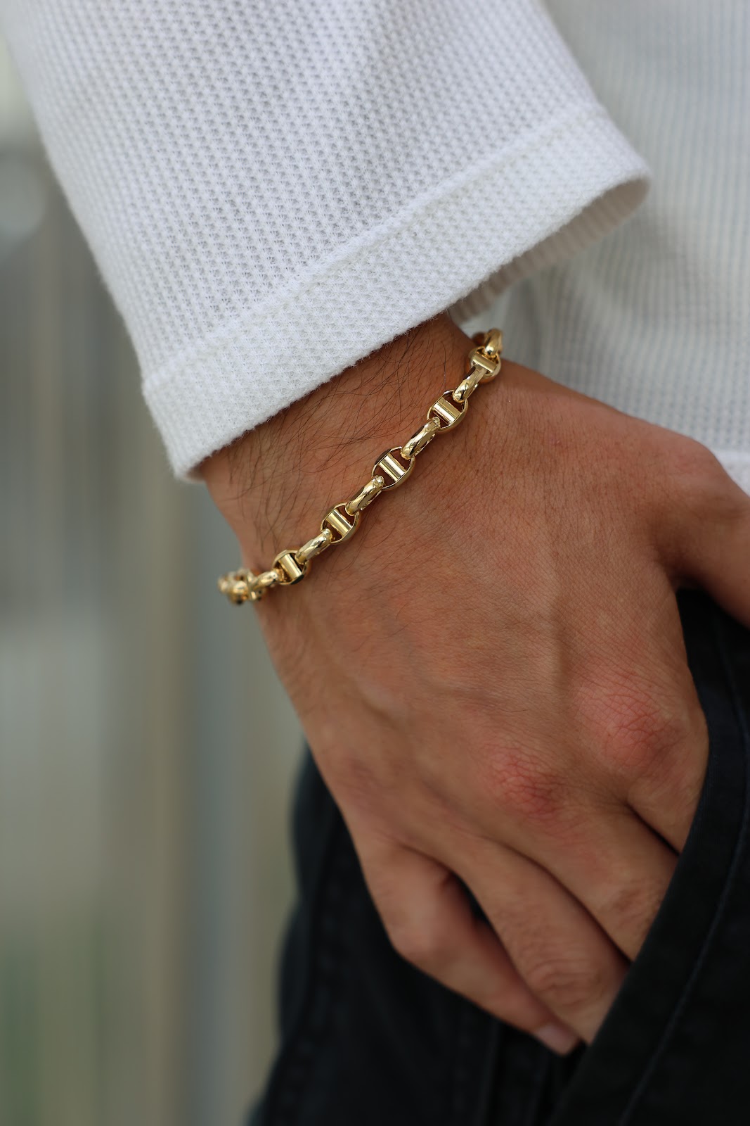 Layered fine gold necklaces at the collarbone