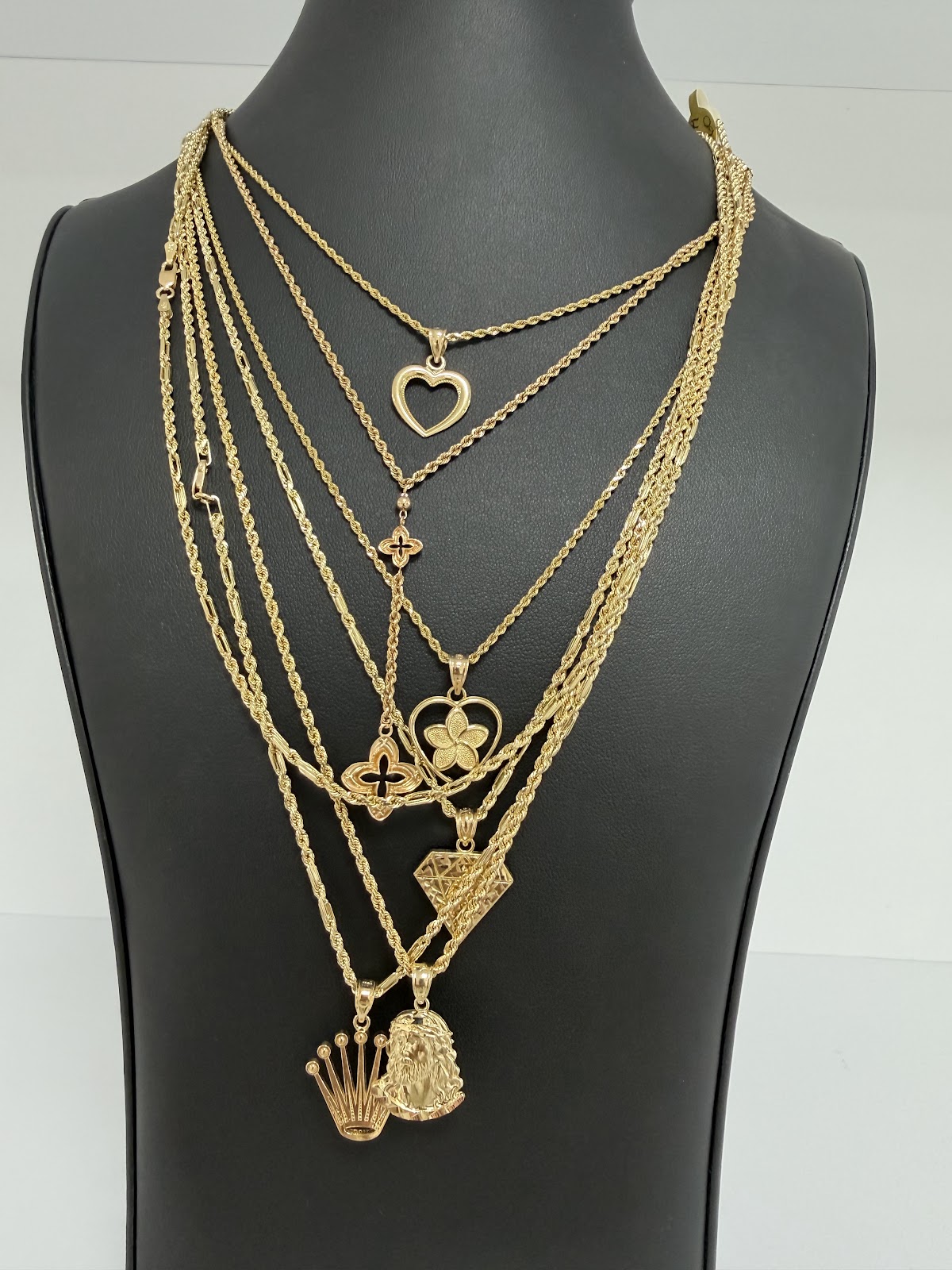 A radiant gold sunburst pendant on a fine chain