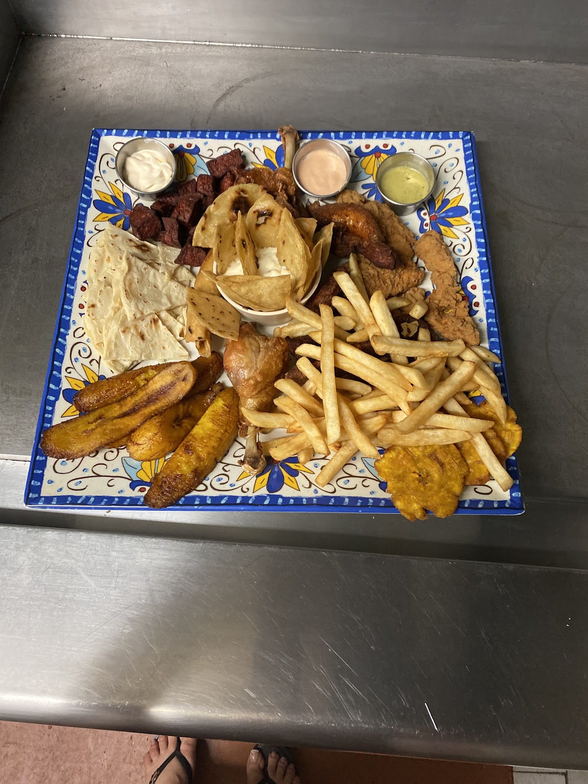 Wood-grilled turbot on a grey plate over dark wood